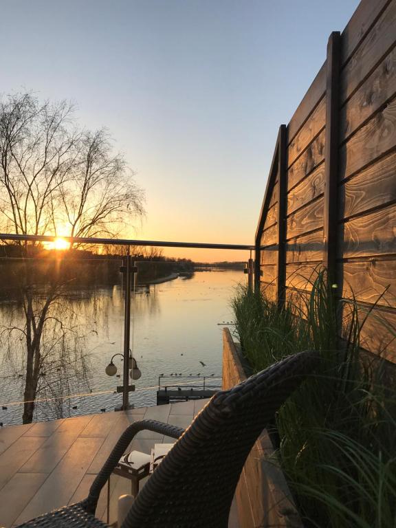 a view of a river with the sunset in the background at Apartament MoLoo II in Ostróda