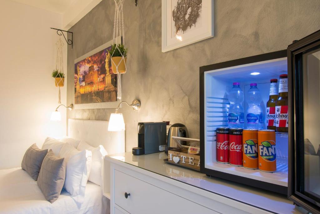a refrigerator filled with lots of bottles of soda at Piccolo Hotel Boutique in Rome