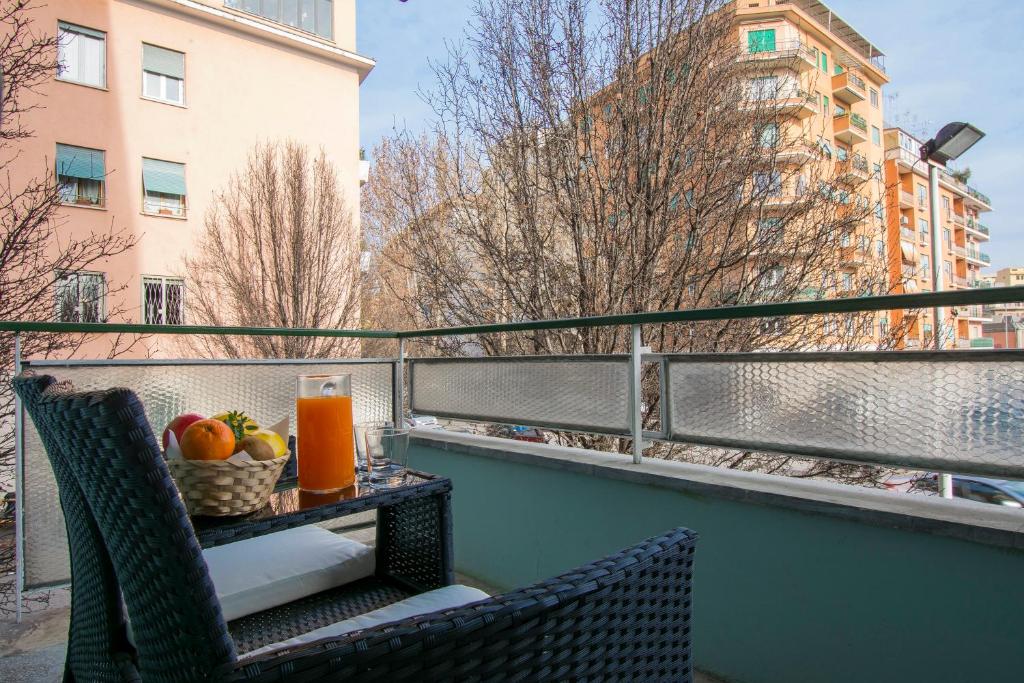a balcony with two chairs and a table with fruit at Piccolo Hotel Boutique in Rome