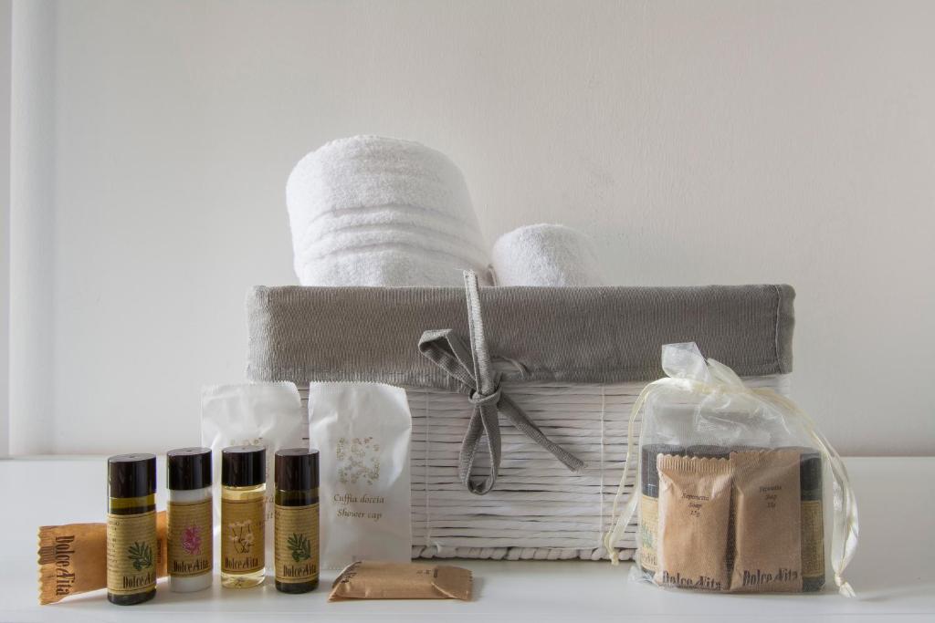 a basket with towels and bottles of essential oils on a counter at Piccolo Hotel Boutique in Rome