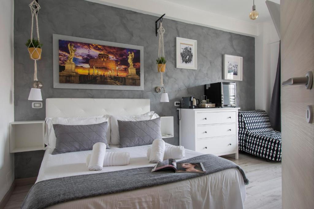 a bedroom with a white bed and a white dresser at Piccolo Hotel Boutique in Rome