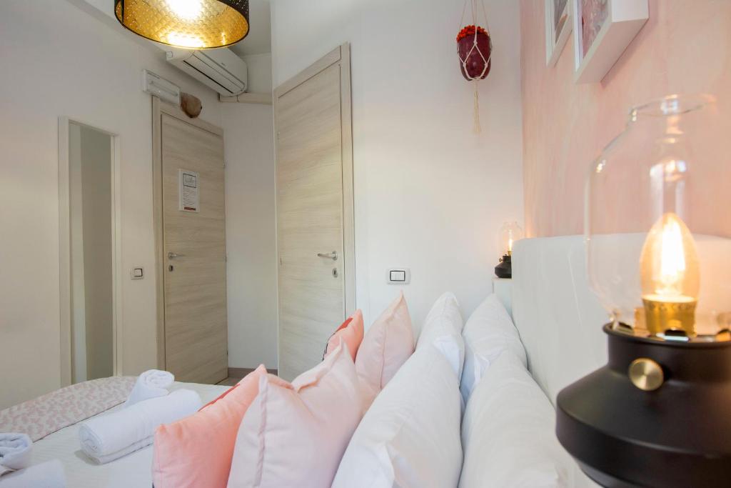 a living room with a white couch with pillows at Piccolo Hotel Boutique in Rome