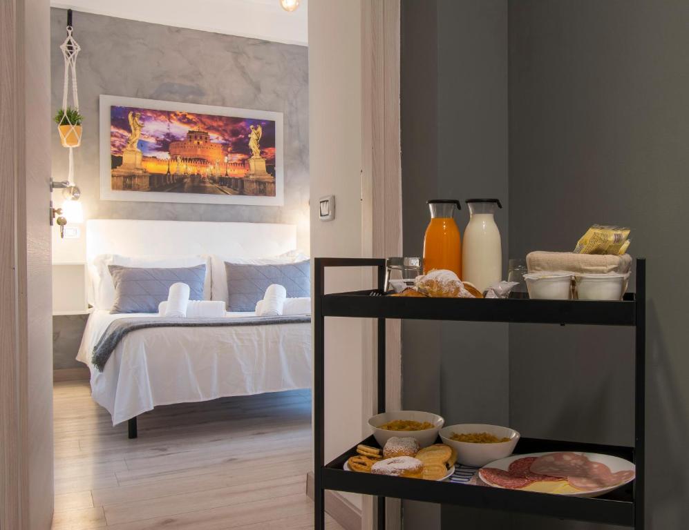 a room with a bed and a shelf with food at Piccolo Hotel Boutique in Rome