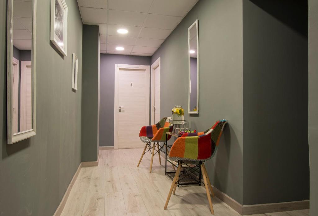 a hallway with a table and chairs in a room at Piccolo Hotel Boutique in Rome