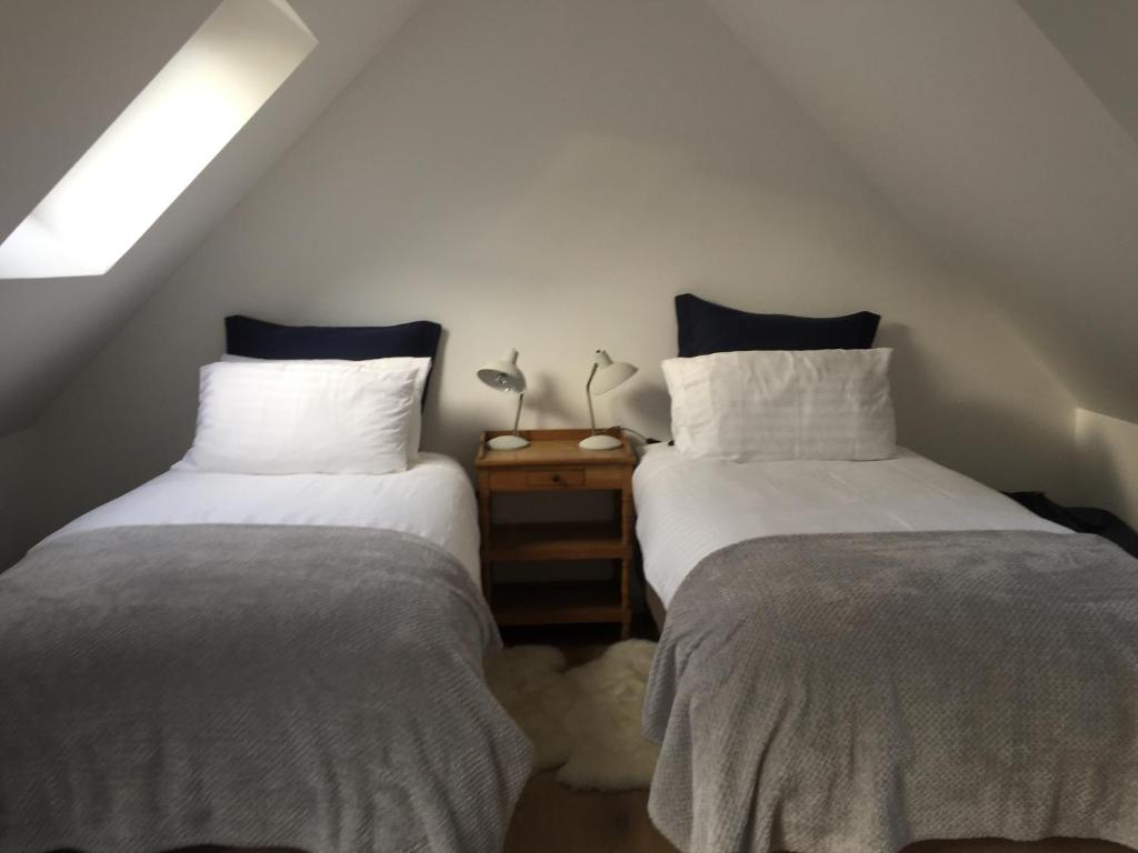 two beds sitting next to each other in a room at The Loft at Craiglea in Pitlochry