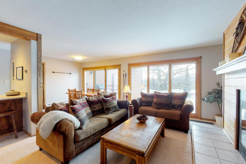 a living room with two couches and a coffee table at Ryan Gulch Condos in Silverthorne