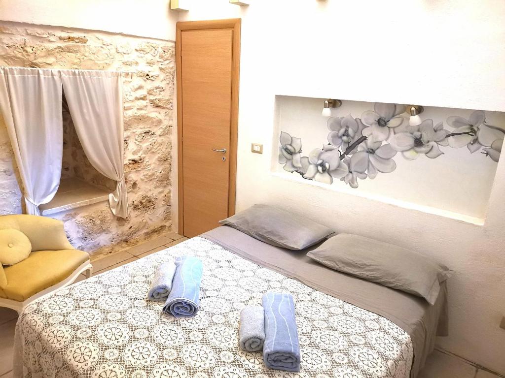 Łóżko lub łóżka w pokoju w obiekcie Trullo Madia e Dimora Giorgio