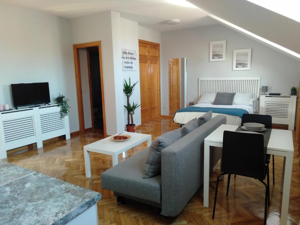 a living room with a couch and a bed at Airport Ifema Barajas Home in Madrid