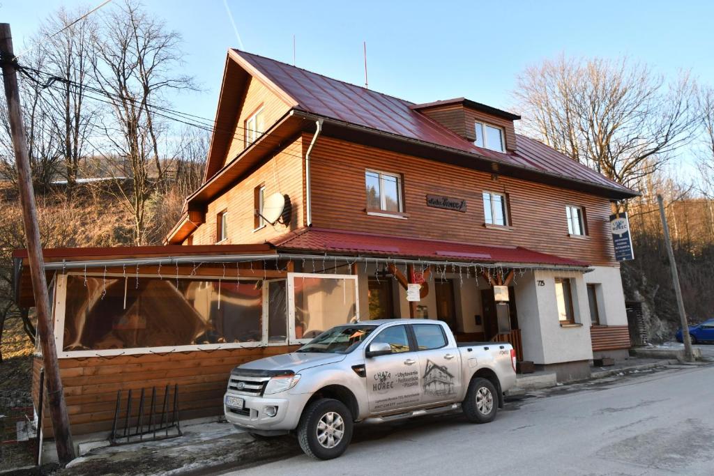 a white truck parked in front of a house at Chata Horec in Liptovské Revúce