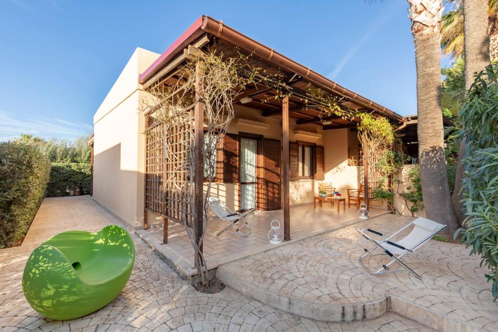 a house with a green object on a patio at VILLA GIAGGIA - VICINO IL MARE in San Vito lo Capo