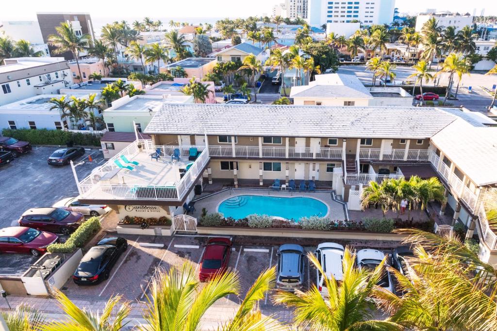 an aerial view of a house with a pool and palm trees at Caribbean Resort Suites in Hollywood