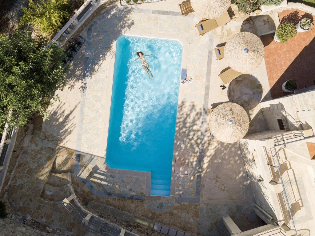 an overhead view of a person swimming in a swimming pool at Prinus Country Retreat Apokoronas, heated pool, 13km from the sea in Embrósneros