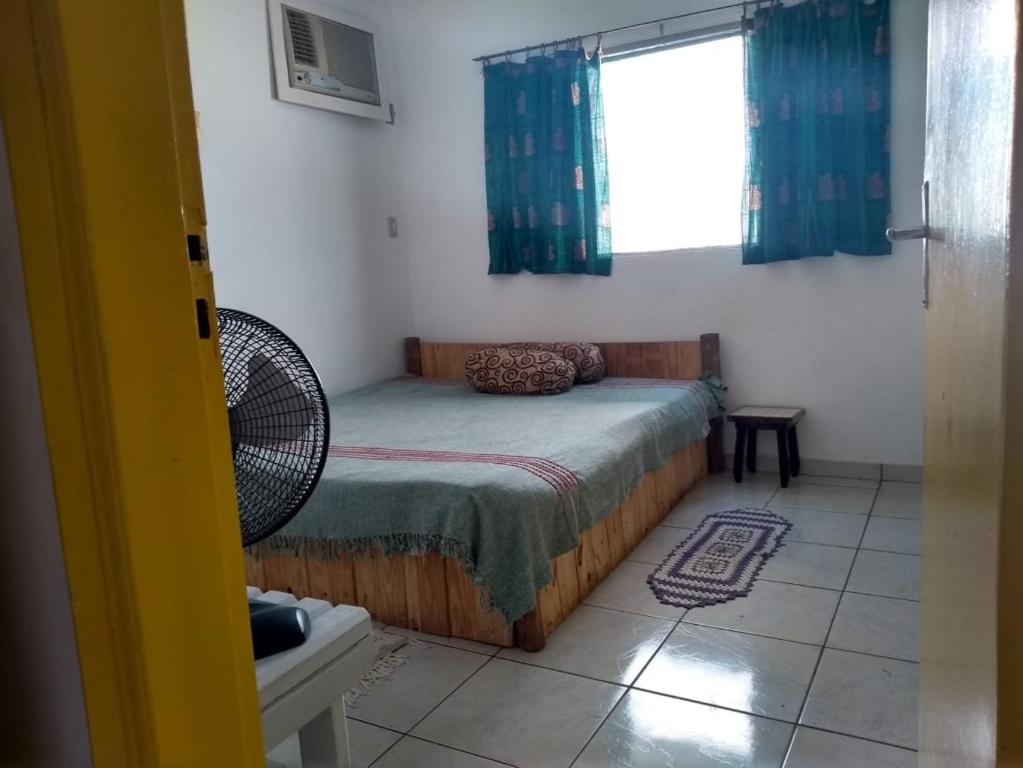 a small bedroom with a bed and a window at Thaumatropio Guest Home in Campo Grande
