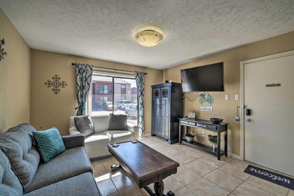 a living room with a couch and a table at Game Day Retreat Pool Access, 2 Mi to Texas A and M in College Station