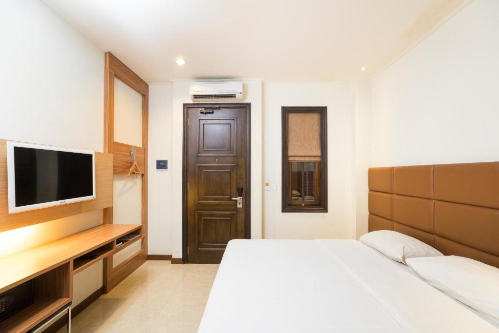 Postel nebo postele na pokoji v ubytování Alron Hotel Kuta