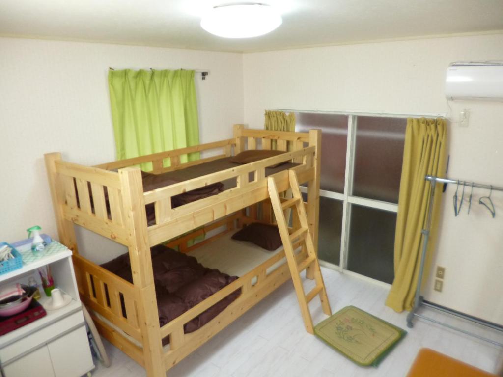a wooden bunk bed in a room with a shower at ザ ミッキー カールトン 井尻 101 in Fukuoka