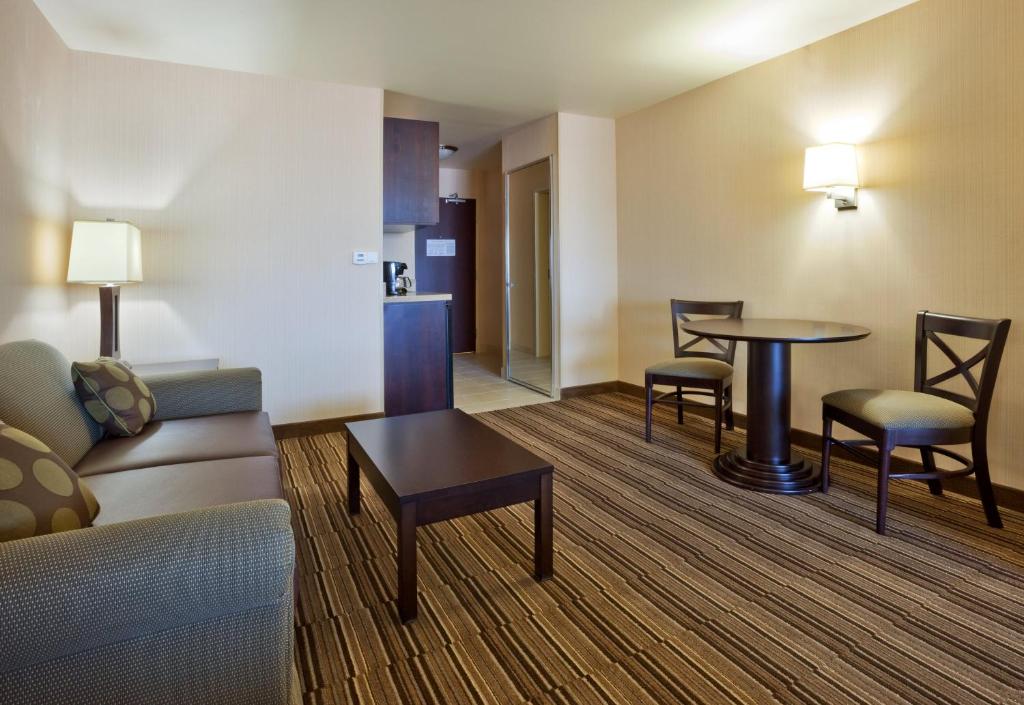 a living room with a couch and a table and chairs at Holiday Inn Express Hotel Twin Falls by IHG in Twin Falls