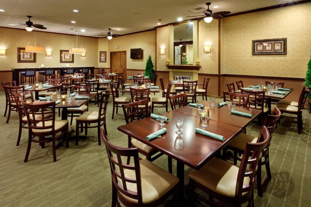 a restaurant with tables and chairs in a room at Holiday Inn Norwich, an IHG Hotel in Norwich