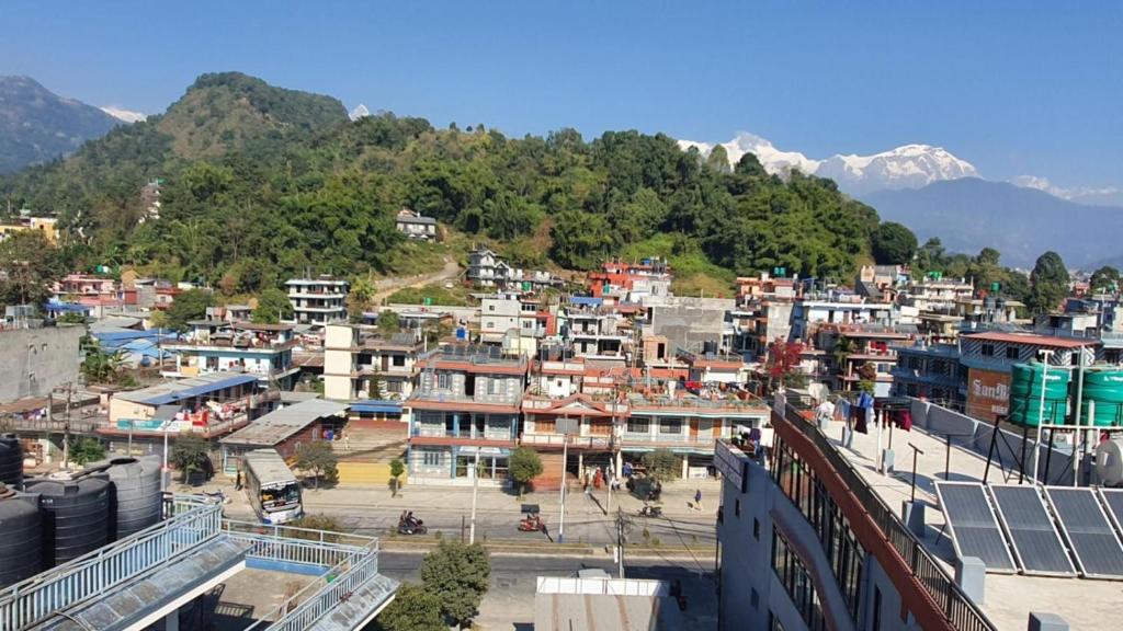 a view of a town with mountains in the background at DnD Apartment Pokhara in Pokhara