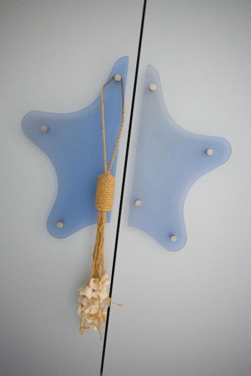 a pair of blue butterfly ornaments on a wall at Scorci Di Mare in Riomaggiore