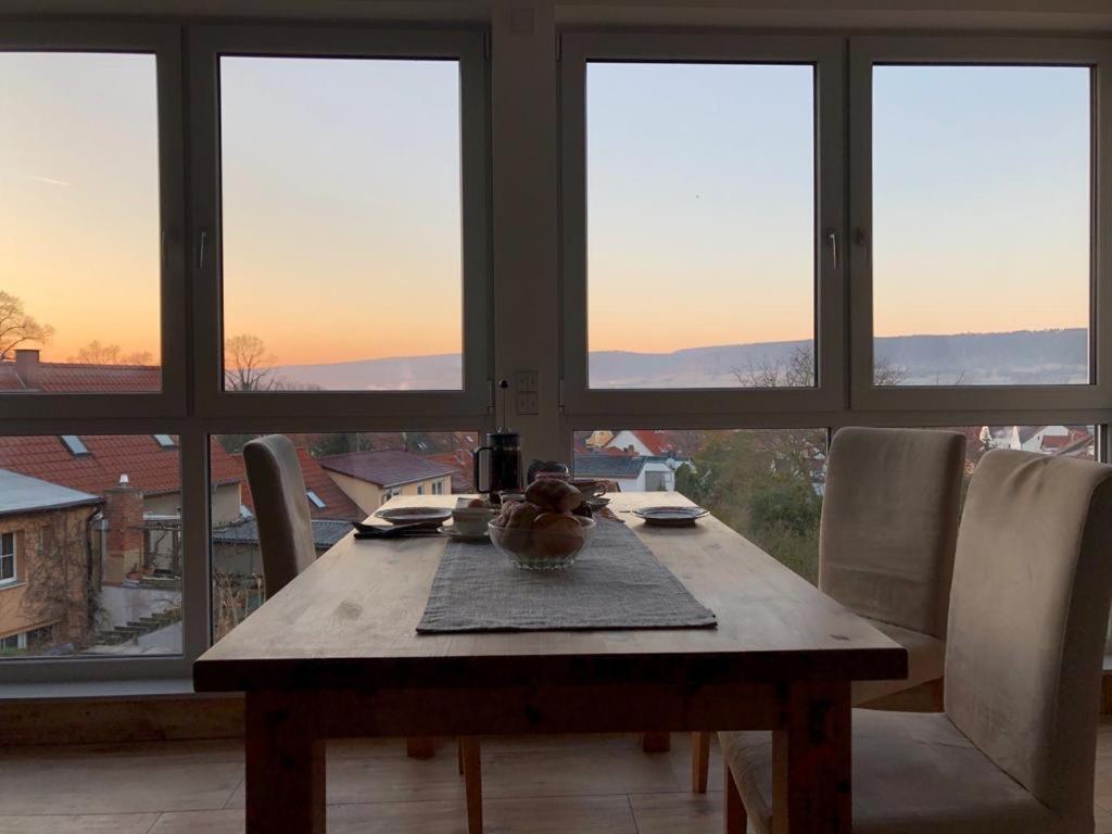 a dining room table with a view of the city at Ferienhaus unterm Schiefen Turm in Bad Frankenhausen