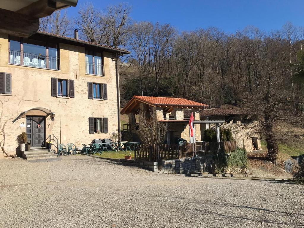 a large stone building with a porch at B&B RONCHI in Castelrotto