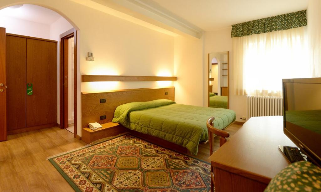 Postel nebo postele na pokoji v ubytování Hotel Compet