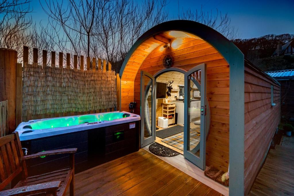 a sauna with a tub in a wooden house at Suilven view in Lochinver