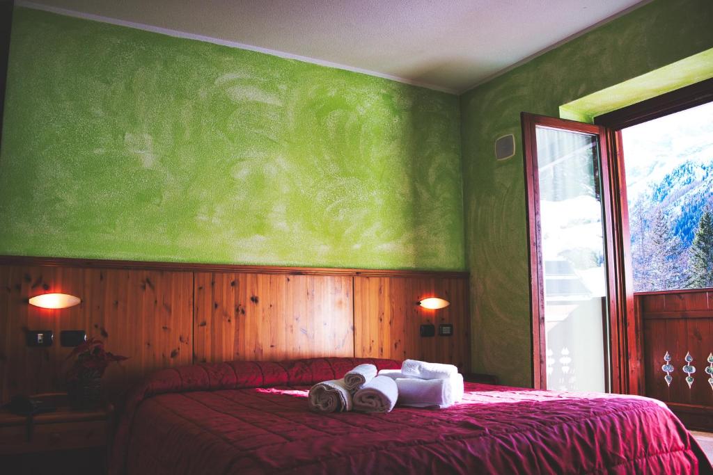 Postel nebo postele na pokoji v ubytování Hotel Gembro