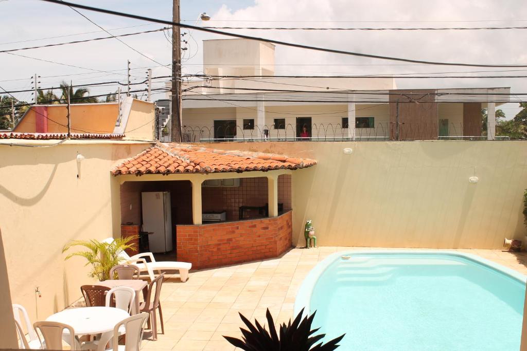 a swimming pool in front of a house at Hotel Pousada Calhau in São Luís