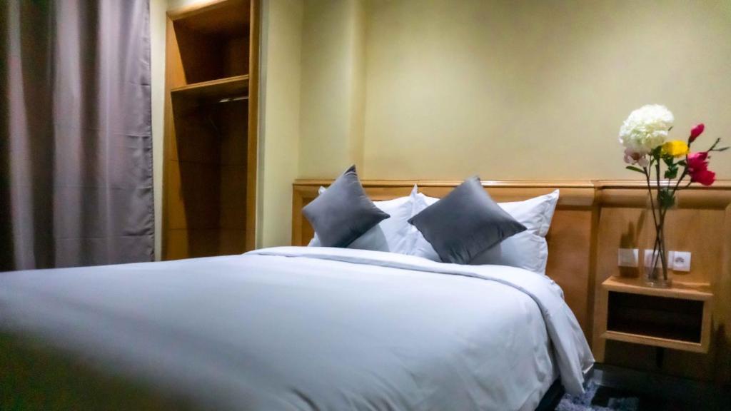 Postel nebo postele na pokoji v ubytování Hotel Golden Flora
