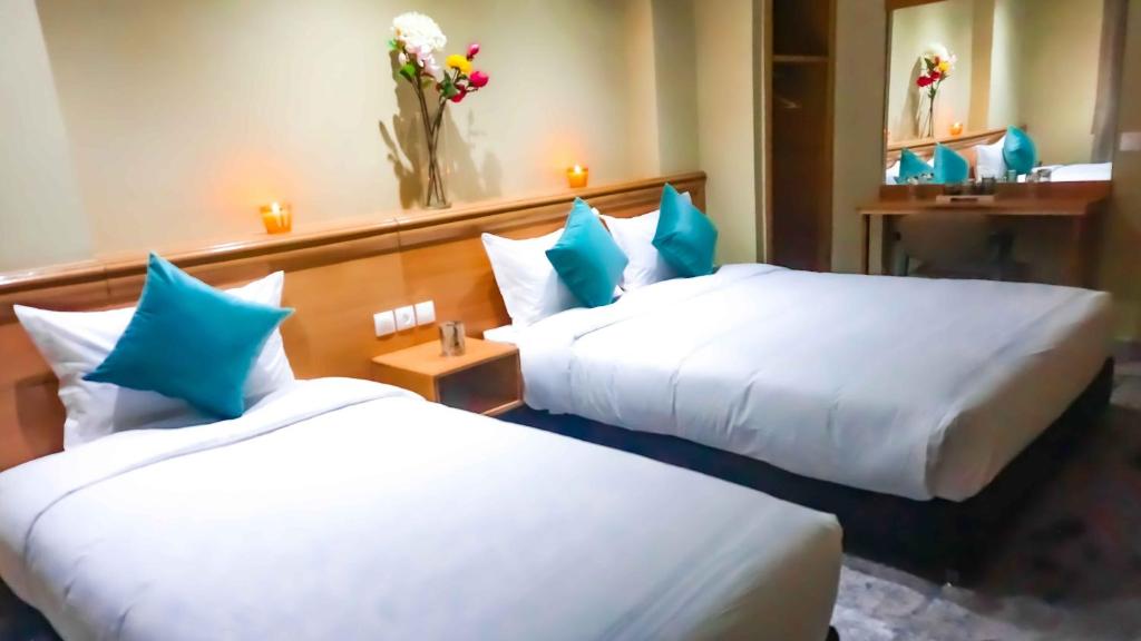 Postel nebo postele na pokoji v ubytování Hotel Golden Flora