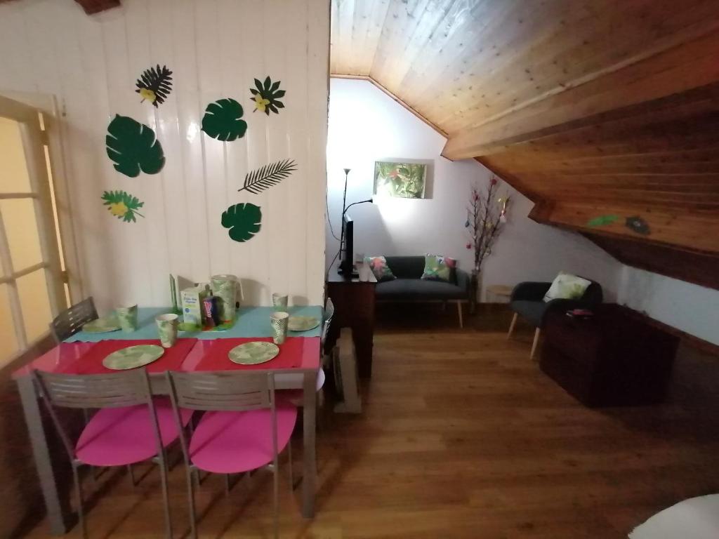 a dining room with a red table and chairs at Cozy Central in Ponta Delgada