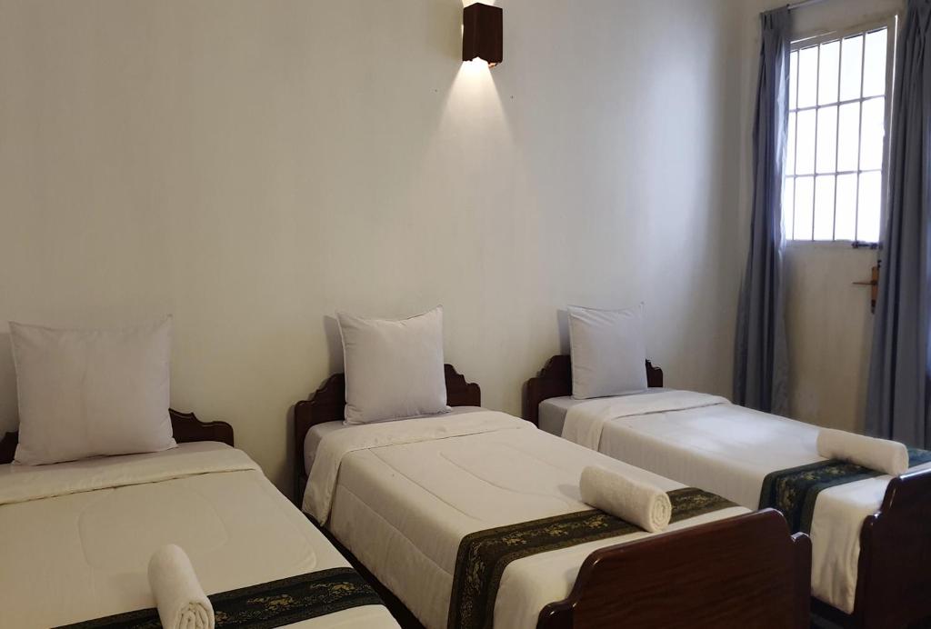 Postel nebo postele na pokoji v ubytování Smiley's Guesthouse