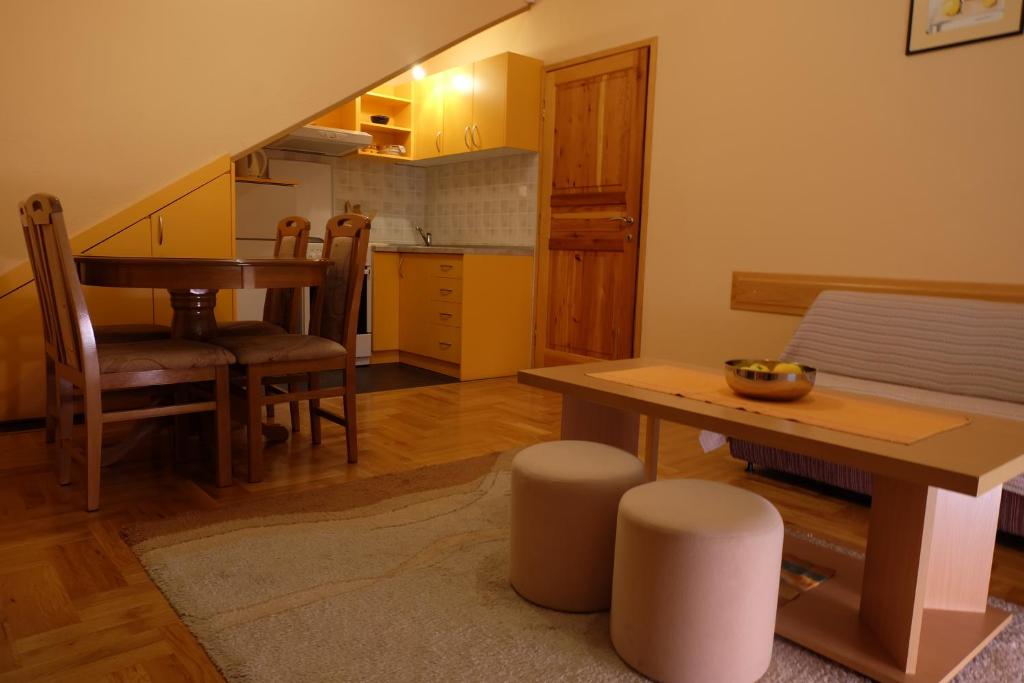 a kitchen and dining room with a table and chairs at Apartment Jadranka in Trebinje