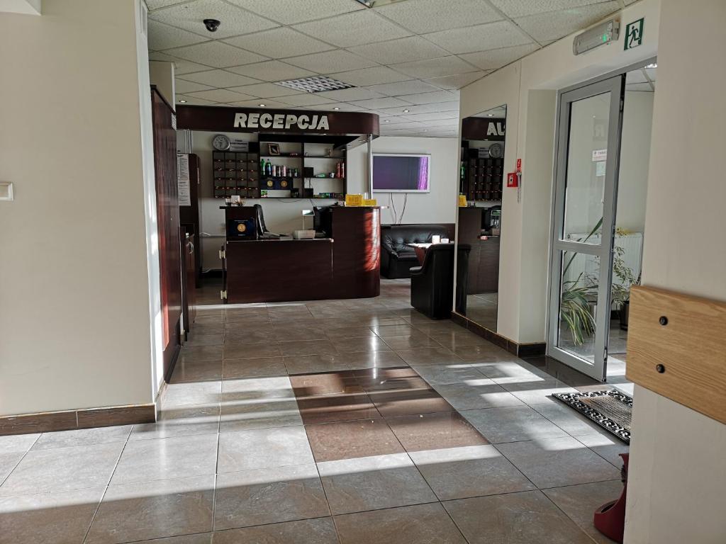 a lobby of a rec room with a reception desk at Hotel Kakadu in Konin