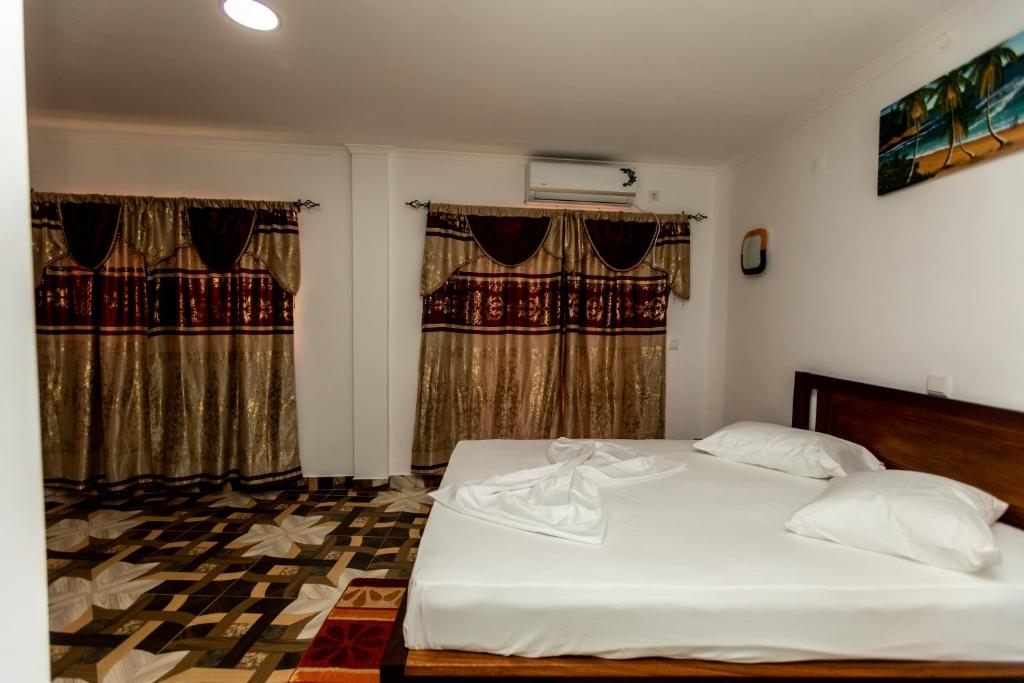 Ένα ή περισσότερα κρεβάτια σε δωμάτιο στο HN City Center Hotel