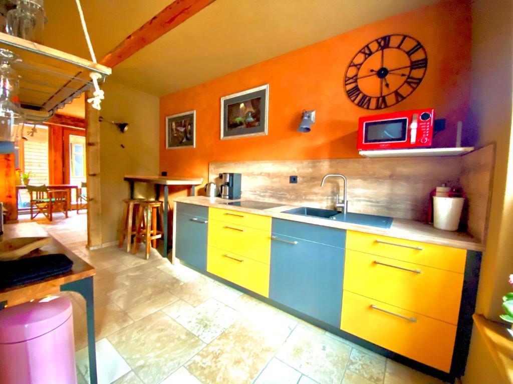 a kitchen with a sink and a clock on the wall at Exklusive ökologische Ferienwohnung EG City in Wernigerode