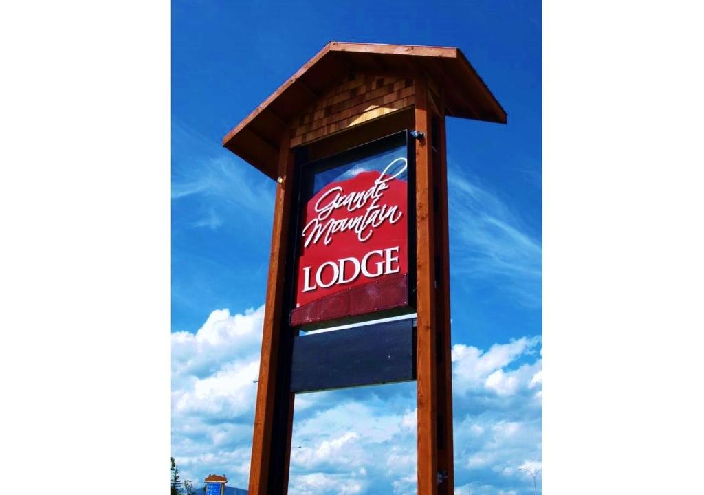 a sign for a cocacola monopoly lodge at Grande Mountain Lodge in Grande Cache