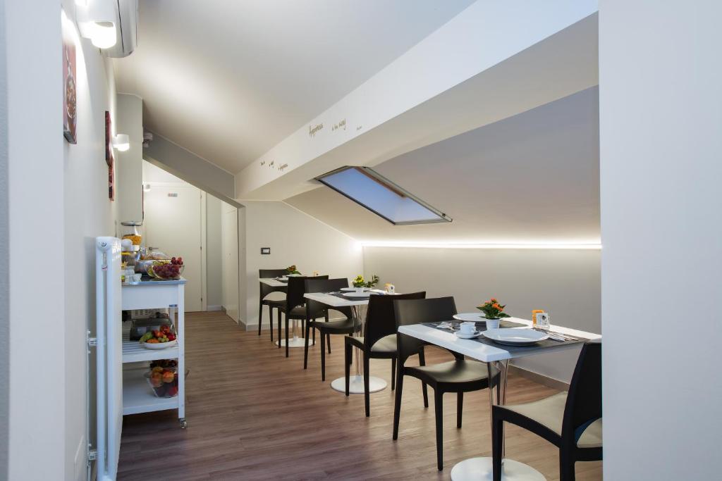 a dining room with tables and black chairs at Etna Sunrise b&b in Zafferana Etnea