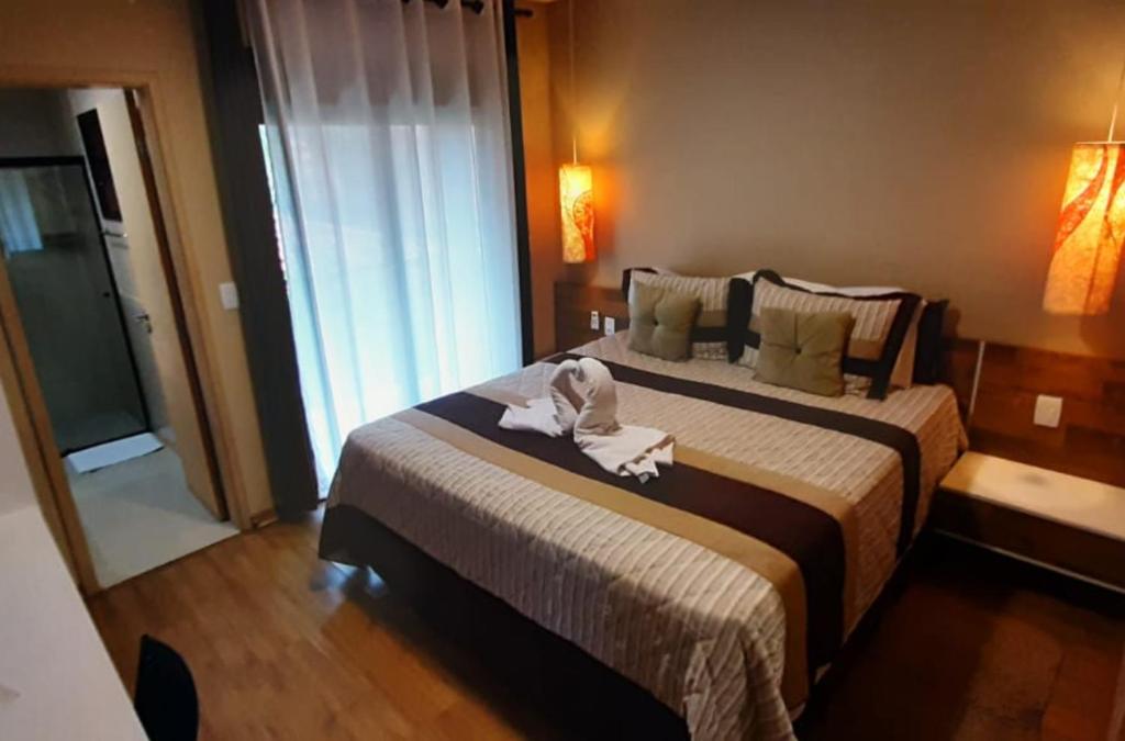 Cama ou camas em um quarto em Amoreiras Hotel Pousada
