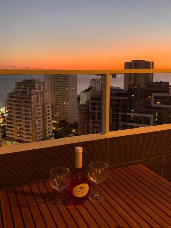 a balcony with two wine glasses and a view of the city at SOLARIS PANORAMIC studio vue mer in Portimão