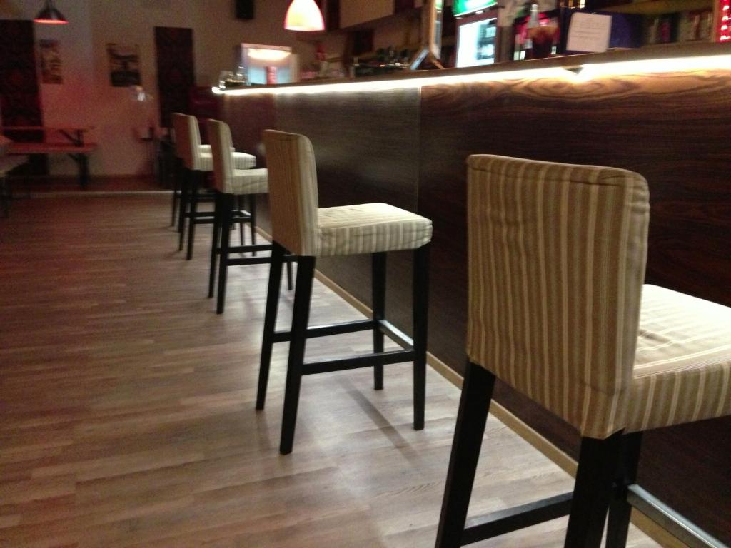 a row of stools at a bar in a restaurant at Whole basement former pub for stag do, bachelor House party flat in Budapest