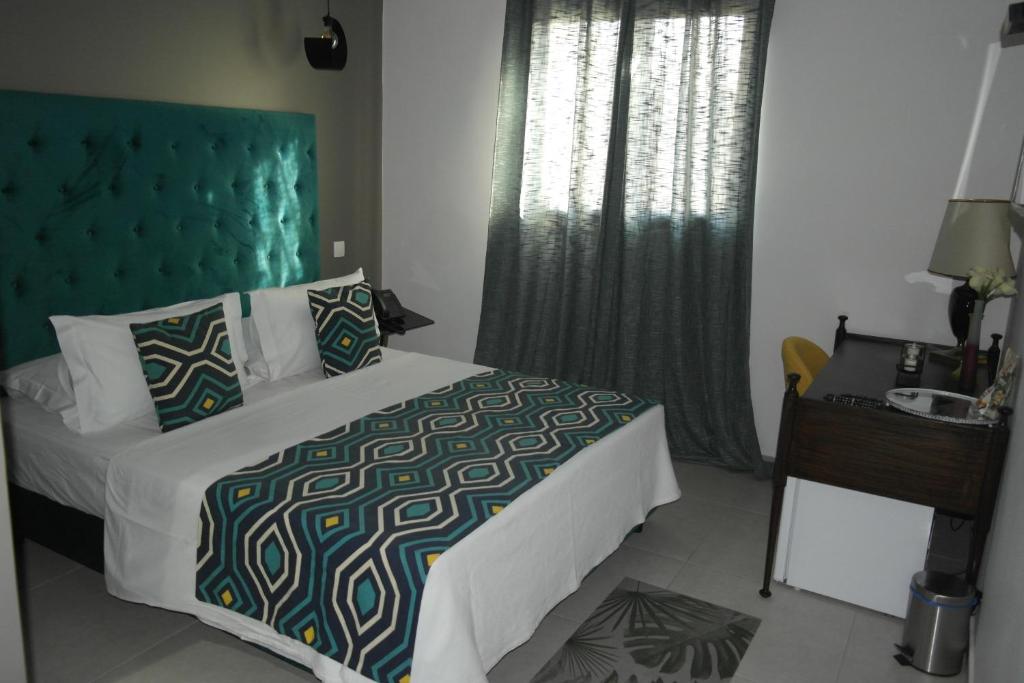 Postel nebo postele na pokoji v ubytování Aparthotel Palace