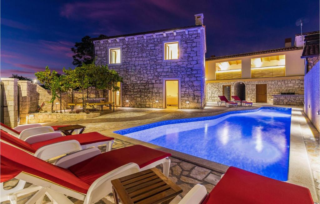 a villa with a swimming pool at night at Awesome Home In Marcana With Kitchen in Orbanići