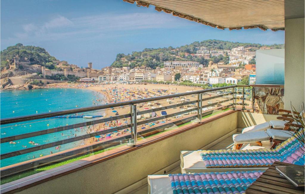 a balcony with a view of a beach and the ocean at Amazing Apartment In Tossa De Mar With Kitchen in Tossa de Mar