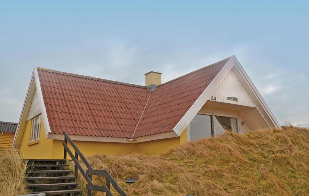 a yellow and white house with a red roof at Beautiful Home In Fan With Sauna in Fanø