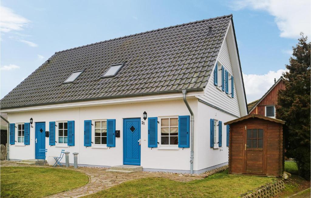 a white and blue house with blue shutters at 2 Bedroom Gorgeous Home In Hohenkirchen in Hohenkirchen