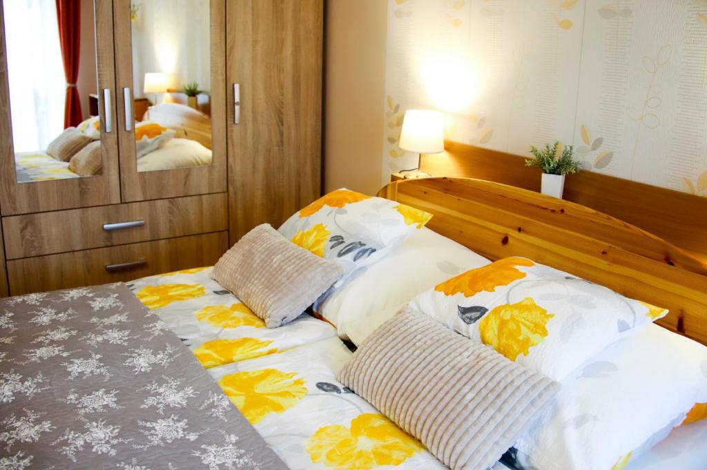 a bedroom with a bed with pillows on it at Dia Apartman in Miskolc