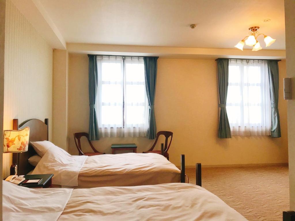 Postel nebo postele na pokoji v ubytování Kitabiwako Hotel Grazie